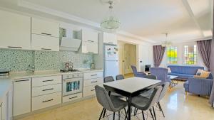 a kitchen and dining room with a table and chairs at Villa Lucia in Fethiye
