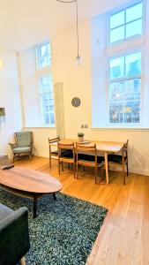 a living room with a table and chairs at Luxury One Bedroom Apartment in the City Centre in Edinburgh