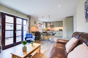 a living room with a couch and a table at Spacious & Modern 2 Bed sleeps 5 in Walthamstow in London