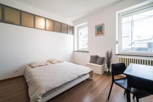 a bedroom with a bed and a table and a chair at En famille ou entre amis in Mondelange