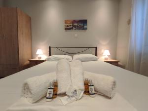 a bedroom with a bed with towels on it at Corfu Pintsis House 2 in Kompítsion