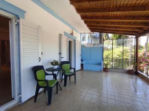 a balcony with a table and chairs on a house at Corfu Pintsis House 2 in Kompítsion