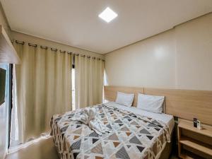 a bedroom with a bed in a room with a window at Pousada Villa Barra Grande in Maragogi