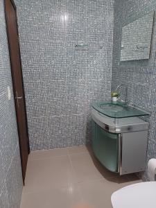a bathroom with a sink and a mirror at Suíte com vista panorâmica in Bombinhas