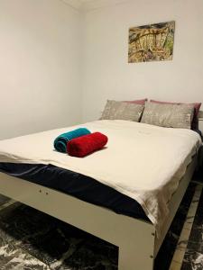 a bed with two pillows on top of it at Queen Size Bedroom Near Sawn River in Perth