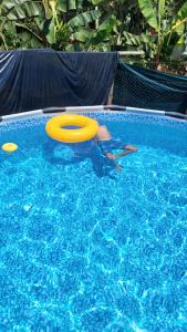 a person playing with a frisbee in a swimming pool at El Encanto Caño Negro in Caño Negro