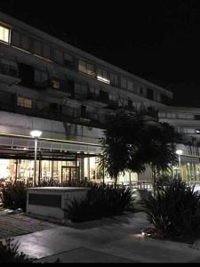 a large building with a lot of windows at night at Excelente estudio premium con amenities in Buenos Aires