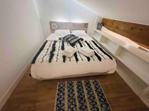 a bed with two towels on it in a room at Maisonnette dans la vallée verte in Fillinges