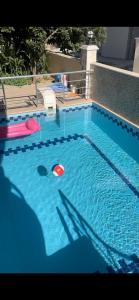 a swimming pool with a red ball in the water at CN Villa Didim in Didim