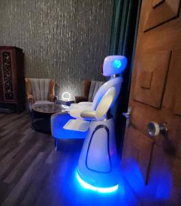 a room with a blue lighted chair in front of a door at Pinnacle Suites in Cowes