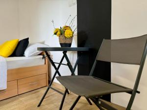 a black chair in a bedroom with a bed at Trsat-Kampus apartments in Rijeka