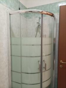 a shower with a glass door in a bathroom at Casa Angela Parma in Parma
