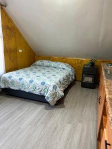 a bedroom with a bed and a desk in it at Departamento Las Rosas in Puerto Montt