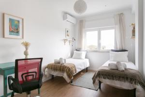 En eller flere senge i et værelse på Apartamento central Setúbal sossegado e com luz