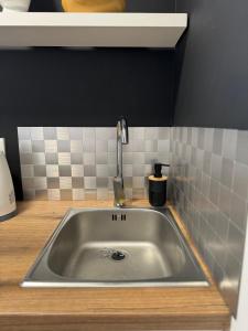 a kitchen sink with a faucet on a counter at Trsat-Kampus apartments in Rijeka +41 photos