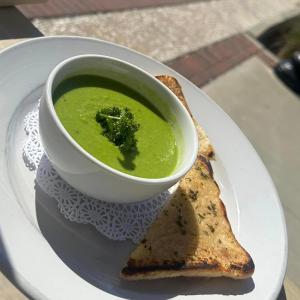 a bowl of soup on a plate with a piece of toast at Riverview Hotel in Saint Marys