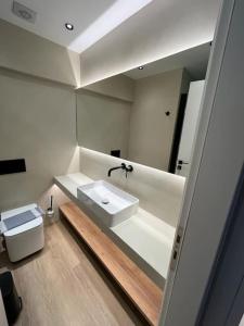 a bathroom with a sink and a mirror at BlueMotion - TwinBedroom Ν2 in Piraeus