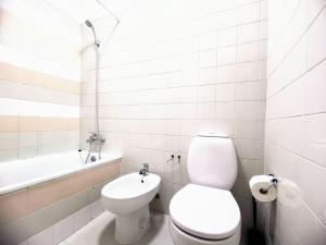a white bathroom with a toilet and a sink at new sunny house! your home Lisbon apartment in Lisbon