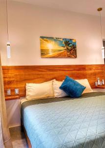 a bedroom with a bed with blue and white pillows at CASA SAN AGUSTÍN #4 in Puerto Escondido +56 photos