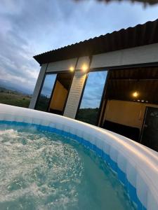 a large swimming pool in front of a house at Glamping monterrio in Santa Rosa de Cabal
