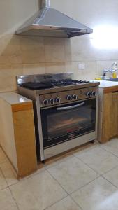 a kitchen with a stove in a kitchen at Departamento con Quincho in Villa Unión