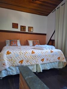 a bedroom with a large bed in a room at Chácara ladeira de Pedra in Salesópolis +56 photos