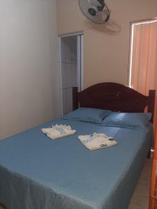 a bedroom with a bed with two towels on it at Apartamentos Central in Triunfo