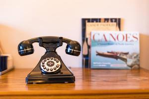 an old fashioned phone sitting on a table at Astoria Hotel in Jasper