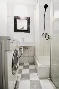 a bathroom with a washing machine and a mirror at Modern Apartment in Millennium City Area in Vienna
