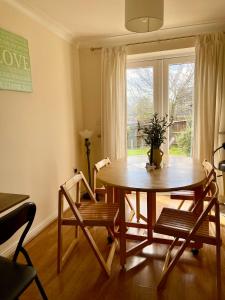 a dining room with a table and chairs and a window at 3 Bedroom Detached house in Wellingborough