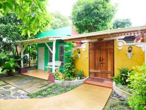 a house with a yellow and green at Forest Bungalows & Mama's Restaurant in Chalong 