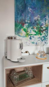 a kitchen counter with a mixer and a painting at Zimmer im Herzen Gößweinsteins in Gößweinstein