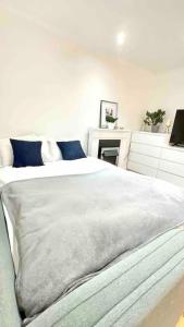 a bedroom with a large white bed and a desk at A beautiful stylish 2 Bedroom Apartment -City of London in London