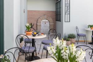 an outdoor patio with chairs and a table and a fireplace at MEDLEY Conceptual Living & Spa in Athens