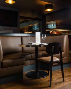 a restaurant with a table and two wine glasses at DoubleTree by Hilton Hotel Newcastle International Airport in Newcastle upon Tyne