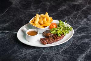 a plate of food with fries and steak and french fries at DoubleTree by Hilton Hotel Newcastle International Airport in Newcastle upon Tyne
