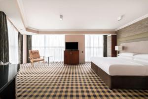 a hotel room with a bed and a television at DoubleTree by Hilton Hotel Newcastle International Airport in Newcastle upon Tyne