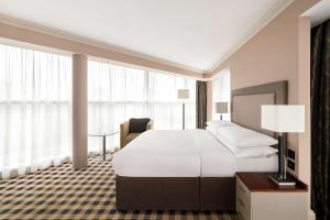 a hotel room with a large bed and a desk at DoubleTree by Hilton Hotel Newcastle International Airport in Newcastle upon Tyne