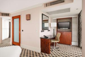 a hotel room with a desk and a television at DoubleTree by Hilton Hotel Newcastle International Airport in Newcastle upon Tyne