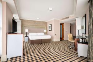 a hotel room with a bed and a television at DoubleTree by Hilton Hotel Newcastle International Airport in Newcastle upon Tyne