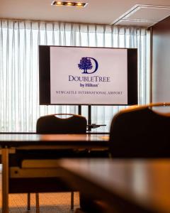 a sign for a conference room with a table and chairs at DoubleTree by Hilton Hotel Newcastle International Airport in Newcastle upon Tyne