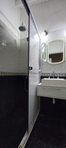 a bathroom with a sink and a mirror at Cómodo dúplex frente al mar in Monte Hermoso +24 photos