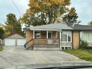 a house with a porch and a driveway at 3 BR GREAT HOUSE WITH 2 parking in Richmond Hill
