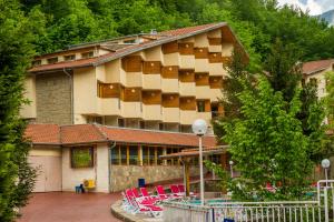 un edificio con sillas rojas delante de él en Diva Hotel & Thermal Pool, en Chiflik