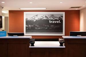 a screen with the words travel on a wall at Hampton Inn & Suites Rochester/Victor in Victor