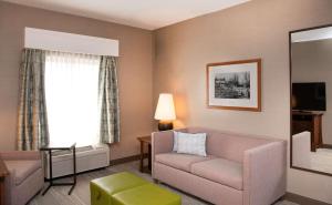 a living room with a couch and a television at Hampton Inn & Suites Rochester/Victor in Victor