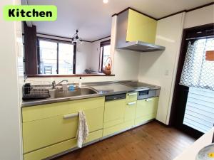 a kitchen with yellow cabinets and a sink at yadoru-i-to-ko-to - Vacation STAY 14261 in Kikugawa