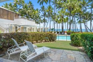 a resort with palm trees and a swimming pool at Belle Escapes Oceanview Suite 11 Alamanda Palm Cove in Palm Cove