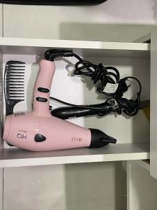 a pink hair dryer sitting on a shelf at Copacabana Beach House in Rio de Janeiro +25 photos