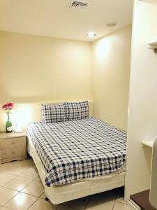 a bedroom with a bed with a checkered blanket at New bedroom queen size bed at Las Vegas for rent-2 in Las Vegas